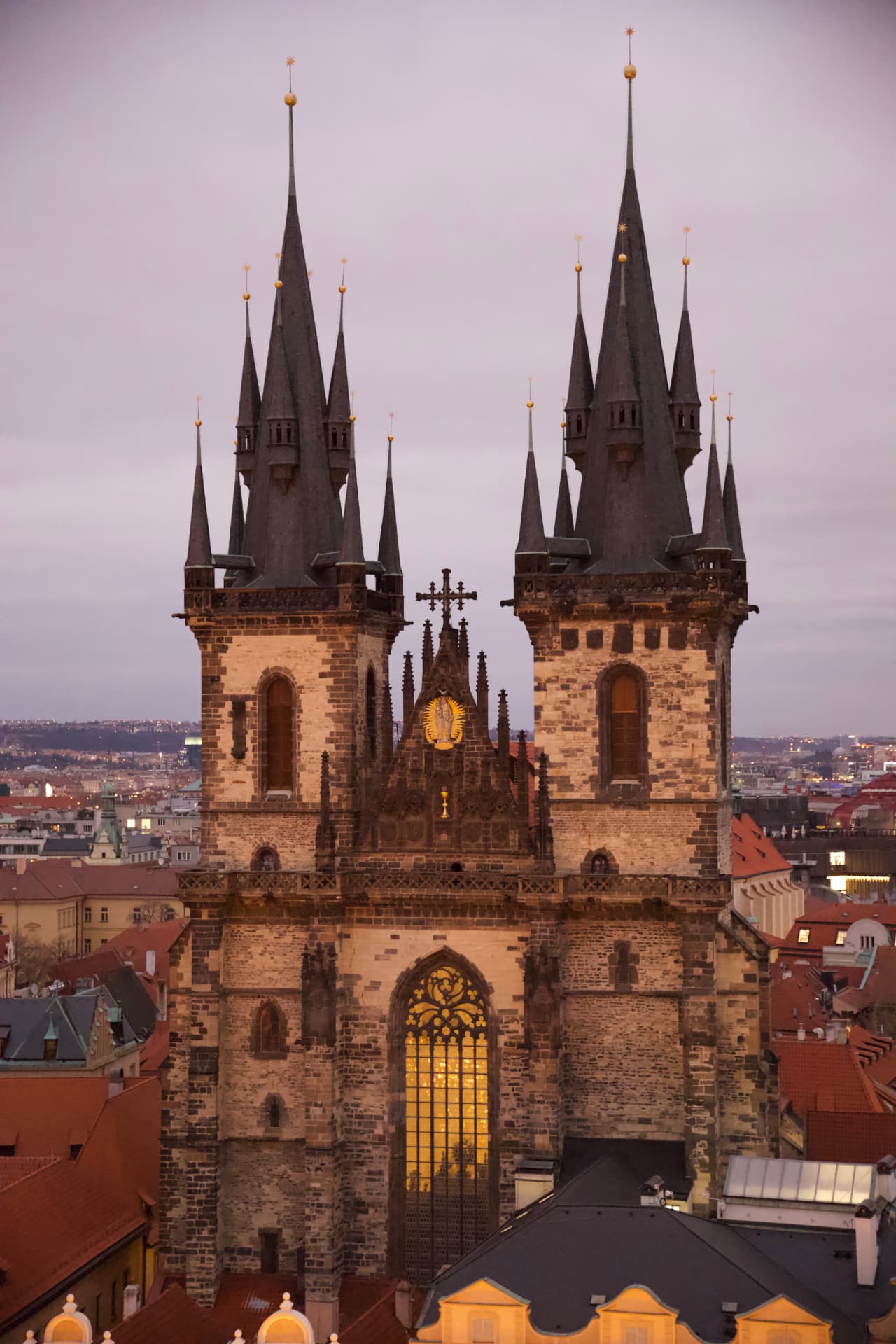 Gothic towers of the Týn Church lit at sunset