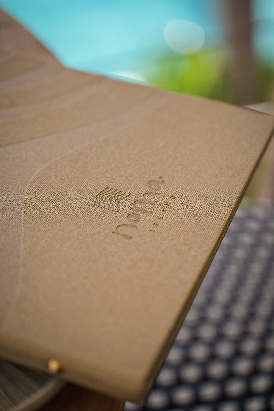 Noma Island logo embossed on a linen menu cover